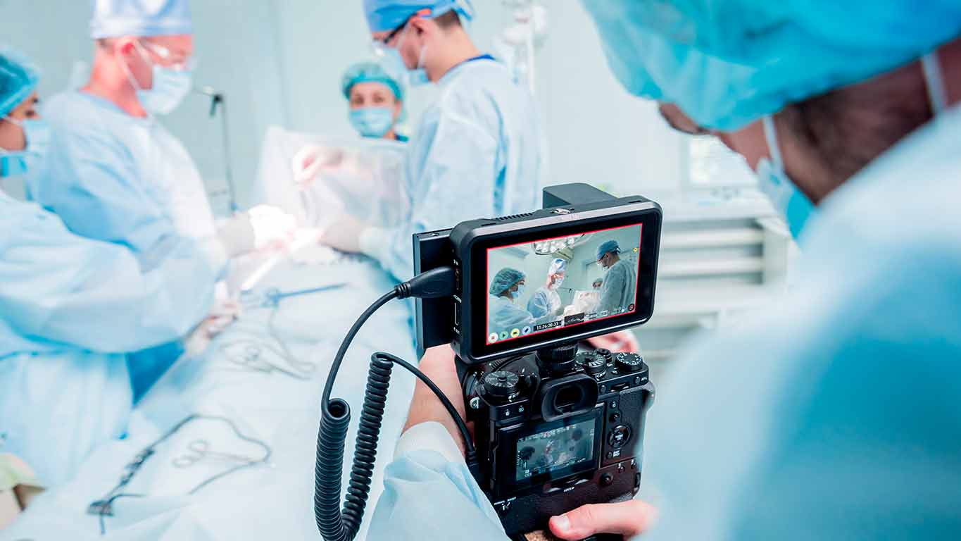 Image of a doctor filming a surgery